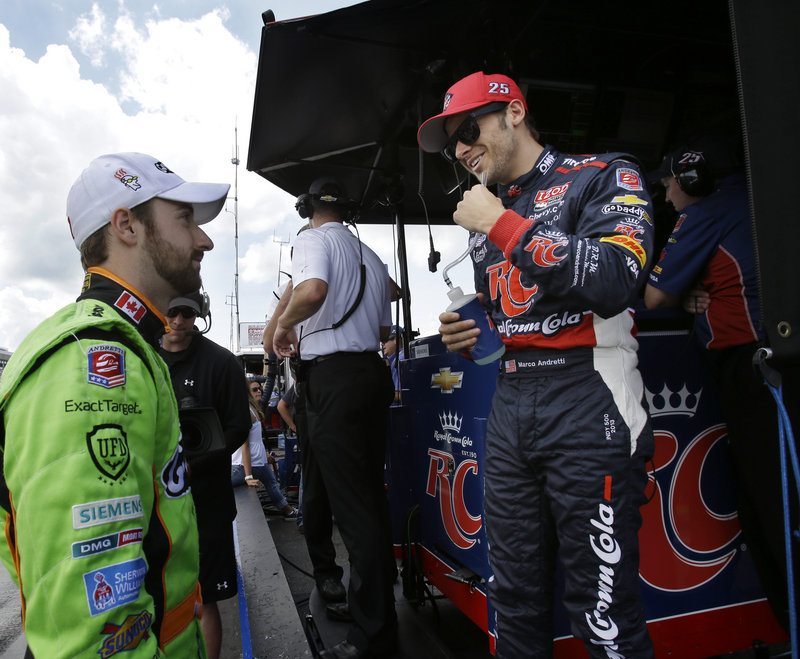 Marco Andretti, right, talks with teammate James Hinchcliffe after winning the pole for Sunday’s IndyCar race at Pocono Raceway. Hinchcliffe qualified third.