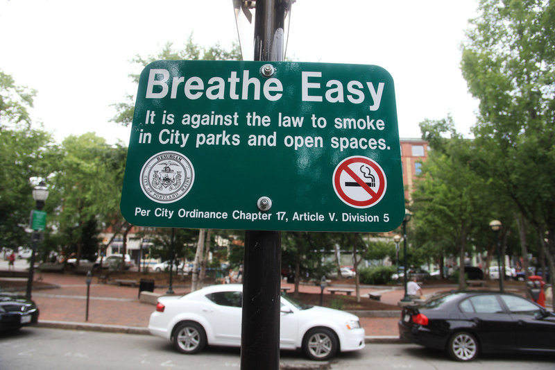 A sign stating "Breathe Easy" hangs at Tommy's Park in Portland on Monday, July 8, 2013. It is against the law to smoke in City parks and open spaces.
