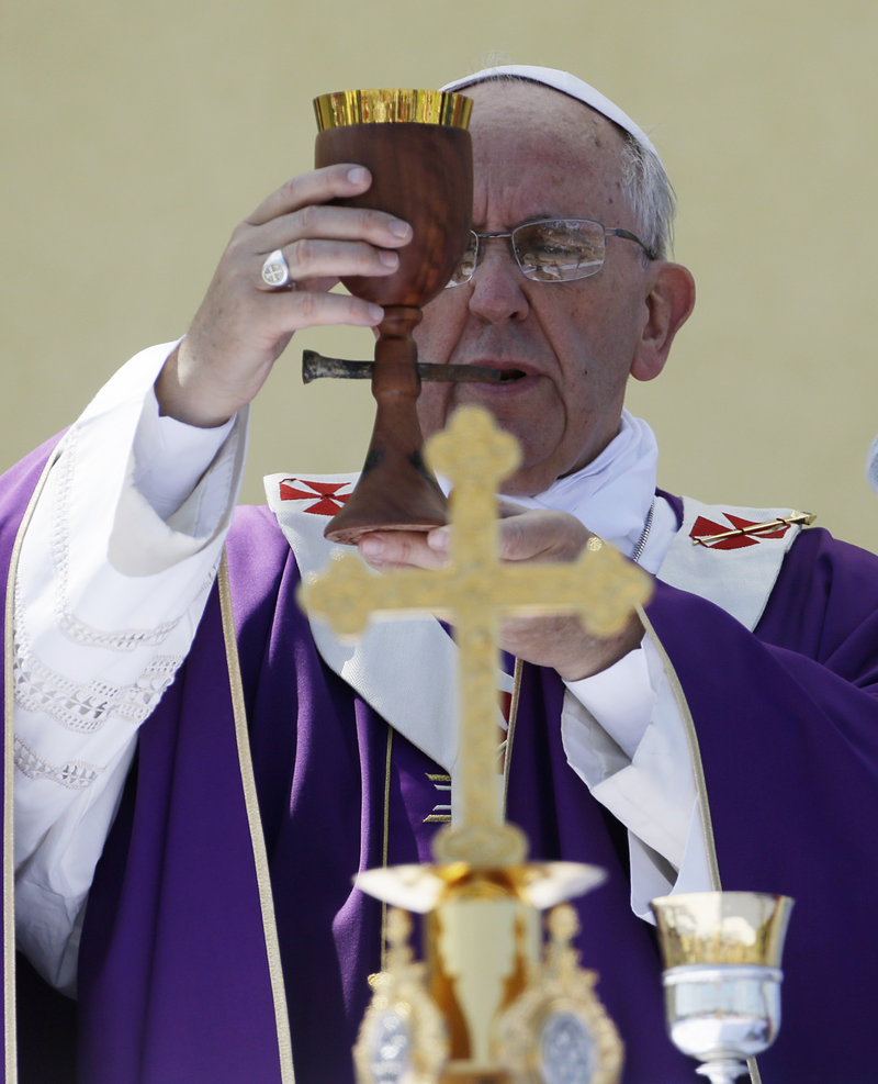 Pope Francis celebrates Mass on Monday with a chalice made from recycled wood from broken migrant boats during his visit to Lampedusa, Italy.