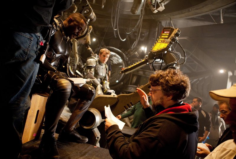 Idris Elba, left, Rob Kazinksy and director Guillermo del Toro on the set of “Pacific Rim.”