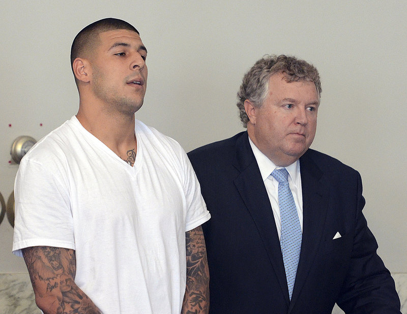 Aaron Hernandez stands with his attorney during his arraignment last month. Hernandez associate Carlos Ortiz said in police documents that another man, Ernest Wallace, said Hernandez admitted to shooting semi-pro football player Odin Lloyd.