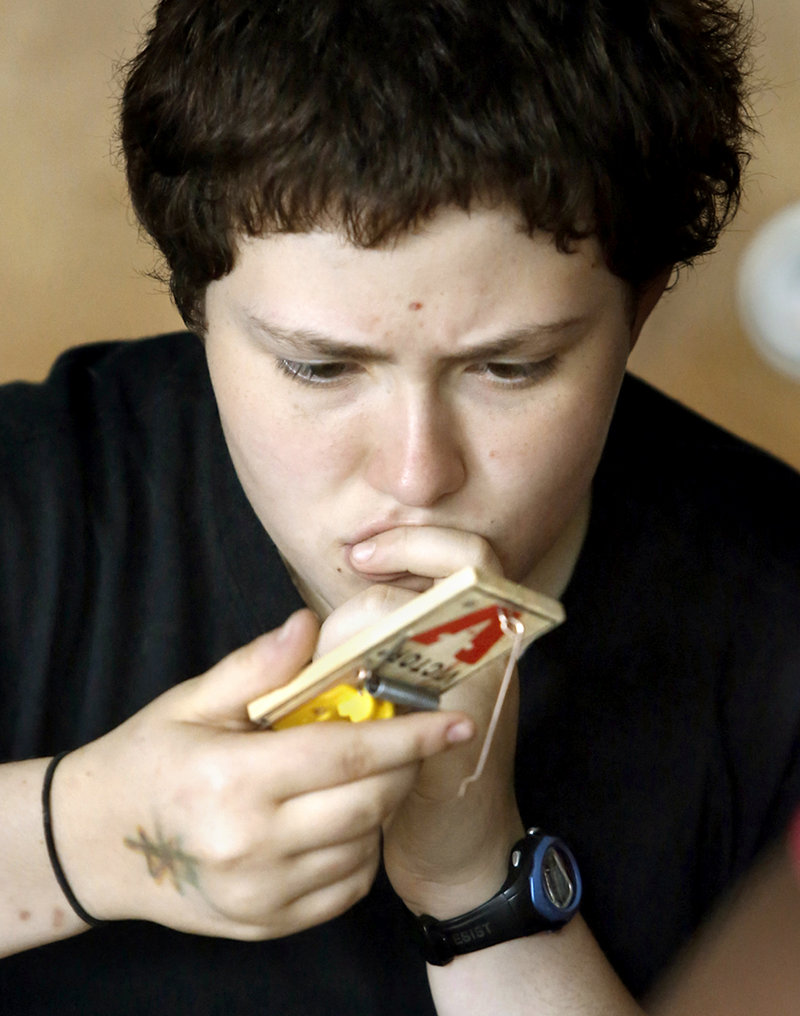 Caitlyn Harrison, 16, from Windham High School, tries to figure out how turn a mousetrap into an engine while building a mousetrap car at the Real School on Mackworth Island in Falmouth on July 10, 2013.