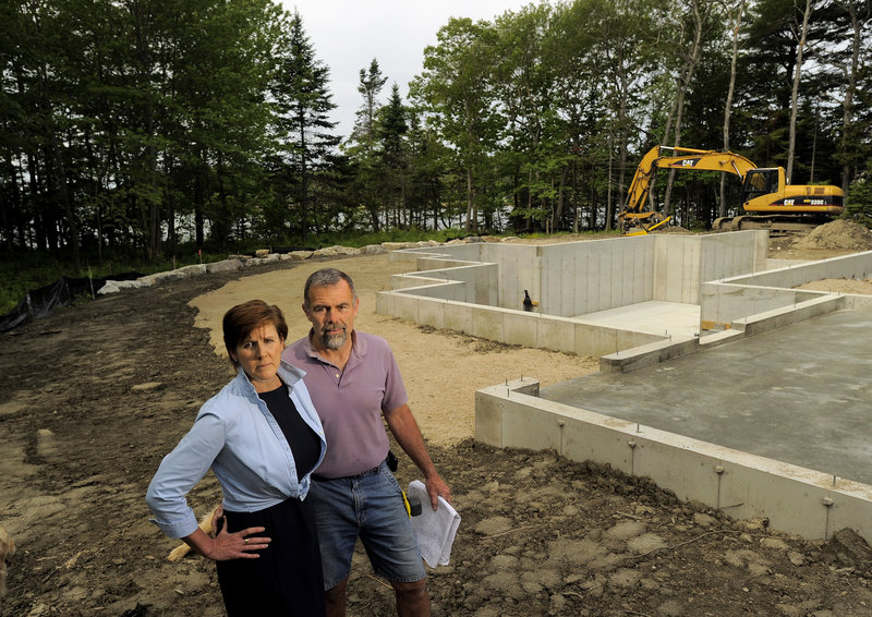 Linda Varrell and her husband, Paul Cormier, say it was difficult and expensive to find insurance for their home being built on Littlejohn Island in Yarmouth. Coastal storms have led to soaring premiums and deductibles for houses on the water’s edge.