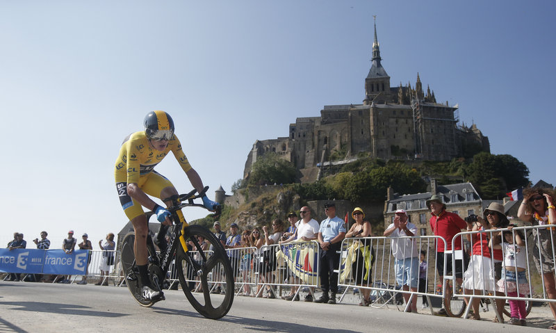 Chris Froome, who has taken command of the Tour de France, passes a world heritage site, Mont-Saint-Michel, a rocky tidal island that holds a monastery, during the 11th stage of the race Wednesday.