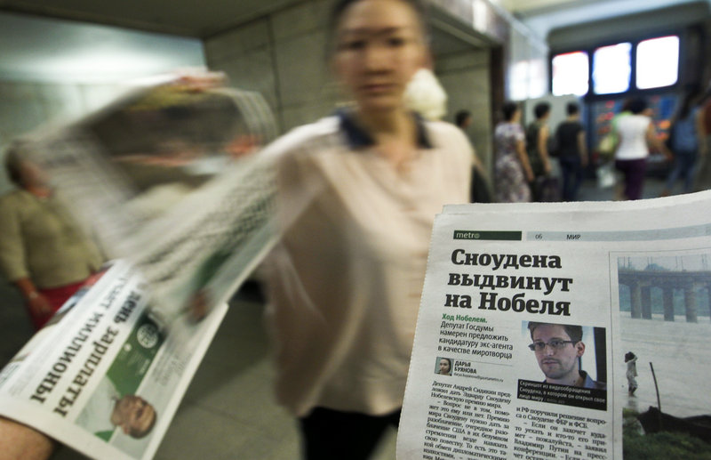 A picture of former U.S. spy agency contractor Edward Snowden is featured prominently on a newspaper at an underground walkway in central Moscow.