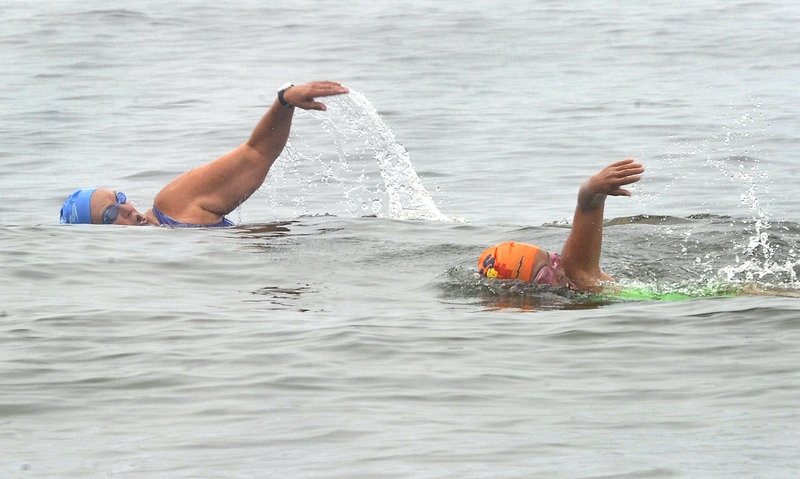 Japanese marathon open water swimmer Miyuki Fujita, right, and Pat Gallant-Charette of Westbrook practice at Scarborough’s Pine Point in preparation for the Peaks to Portland swim on Saturday.