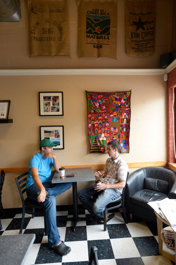 Patrons Brian King of Gorham and Clark Carter of Portland converse last week at Coffee By Design’s Washington Avenue location in Portland.