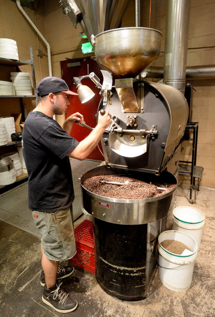 Asa Korsen roasts Peruvian coffee at Coffee By Design’s Washington Avenue facility on Thursday, Co-owner Alan Spear said the company currently offers 35 different coffees and blends, excluding flavored coffee, from 17 countries.