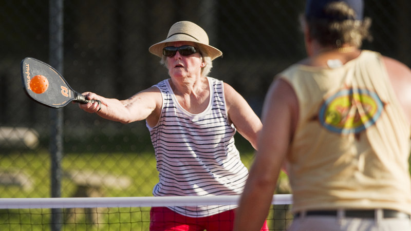 Yvonne Kingsley, 64, of West Baldwin, returns a volley while playing pickleball at Sunset Ridge Golf Course in Westbrook on Friday, July 5, 2013. Pickleball is a game similar to tennis, played with oversized ping pong paddles and a plastic ball like a whiffleball on a small tennis court with a 34-inch net.