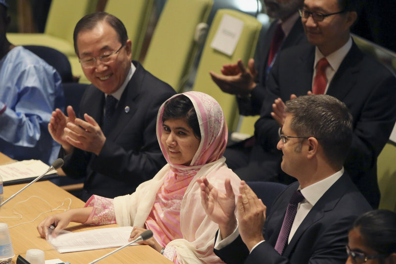 United Nations Secretary-General Ban Ki-moon, left, applauds as members of the “Malala Day” Youth Assembly wish Malala Yousafzai, center, a happy birthday Friday.