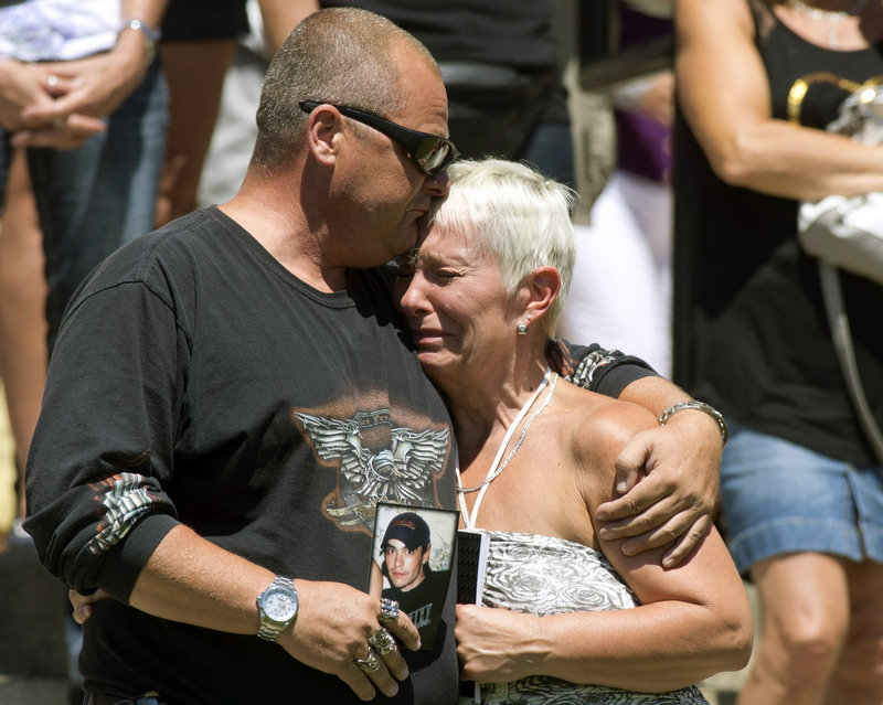 Lise Doyon, right, is comforted by her friend Jeannot Labrecque, as church bells chime 50 times Saturday in the Canadian town of Lac-Megantic for the victims of the train explosion July 6. Doyon lost her son Kevin Roy and her daughter-in-law in the accident.