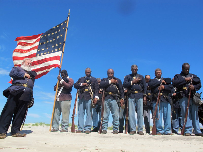 Re-enactors pray on the beach on Morris Island in Charleston, S.C., in a ceremony honoring the 54th Massachusetts Volunteer Infantry, the black Union unit that attacked Confederate Battery Wagner, in a fight recounted in the film “Glory.”