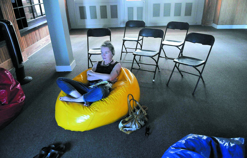 Karen Young watches MIFFOnEdge’s presentation of Nam Jun Paik’s “Global Groove,” a video made in the 1970s, from a beanbag chair at the old post office in downtown Waterville on Saturday.