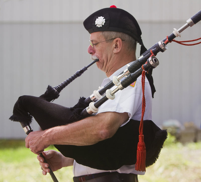 Rob Simmons, founder of the Guns ’N Hoses Pipes and Drums of Maine, plays the bagpipes at his Falmouth home on Saturday.