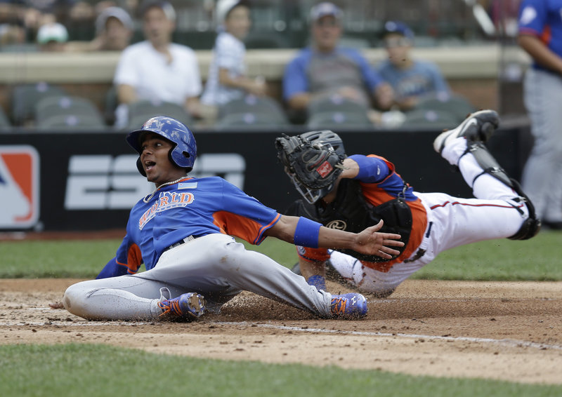 World’s Xander Bogaerts, a former Portland Sea Dog, scores ahead of the tag by United States’ Austin Hedges in the fourth inning of the All-Star Futures game Sunday. Bogaerts was 2 for 3 in the game, which the U.S. team won 4-2.