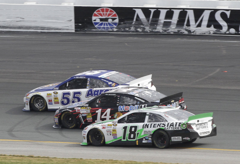Brian Vickers (55) leads by a nose over Tony Stewart (14) with Kyle Busch (18) just behind at New Hampshire Motor Speedway in Loudon, N.H., Sunday afternoon.