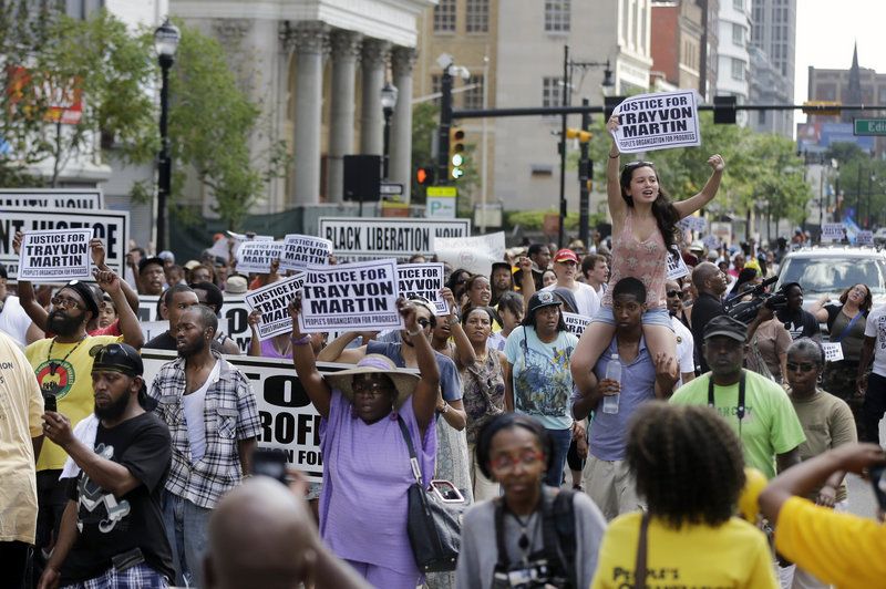 A large crowd marches along Broad Street, in Newark, N.J., Sunday to protest the acquittal in George Zimmerman’s murder trial.