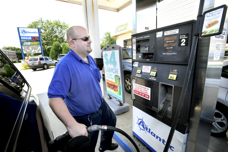 Tom Vire of Westbrook fuels up Monday at the Atlantic station on Broadway in South Portland. Maine’s average price for regular gas was $3.71 Monday, 7 cents above the national average. A month ago the Maine price was $3.58, 6 cents below the national average.