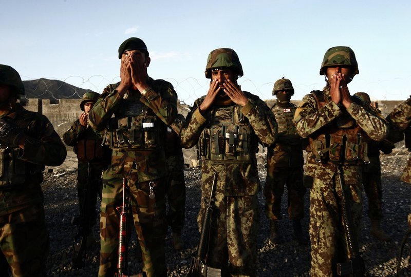 Afghan soldiers pray before a patrol in Maidan Shar. Many military operations lie ahead for the soldiers as they prepare to take on full responsibility for trying to hold the Taliban at bay.