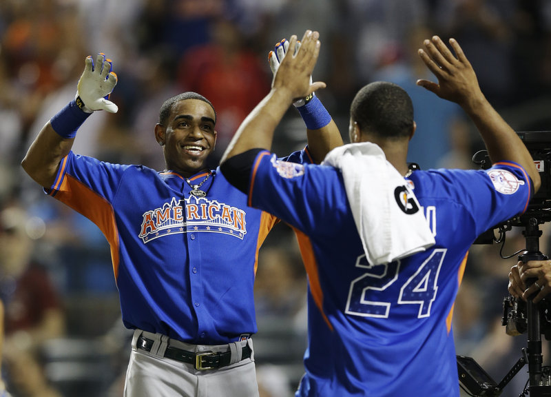 It’s a double high-five for Yoenis Cespedes, left, as the Oakland Athletics slugger, celebrates with Robinson Cano after winning the MLB All-Star baseball Home Run Derby at Citi Field in New York City on Monday night.