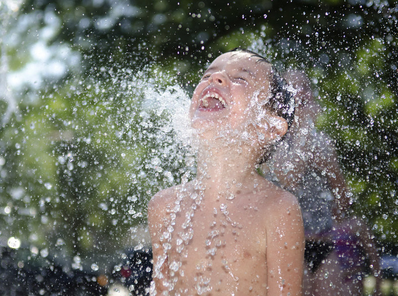 Four-year-old Dean Geiger of Dixon, Ill., keeps cool at a splash pad park as hot, steamy weather settled over much of the nation. The National Weather Service issued advisories in many areas where the heat index hit triple digits.
