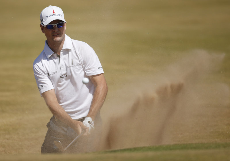 Zach Johnson knocks his ball out of a bunker Thursday during the first round of the British Open at Muirfield. Johnson grabbed the lead with a 5-under 66.