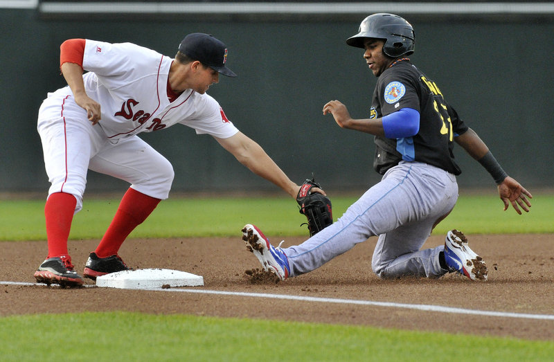 Third baseman Garin Cecchini applies the tag on Maikel Franco of the Reading Fightin Phils, who was out while attempting to advance from second base when a pitch went to the backstop in the first inning Thursday night at Hadlock Field. Franco finished with three hits.