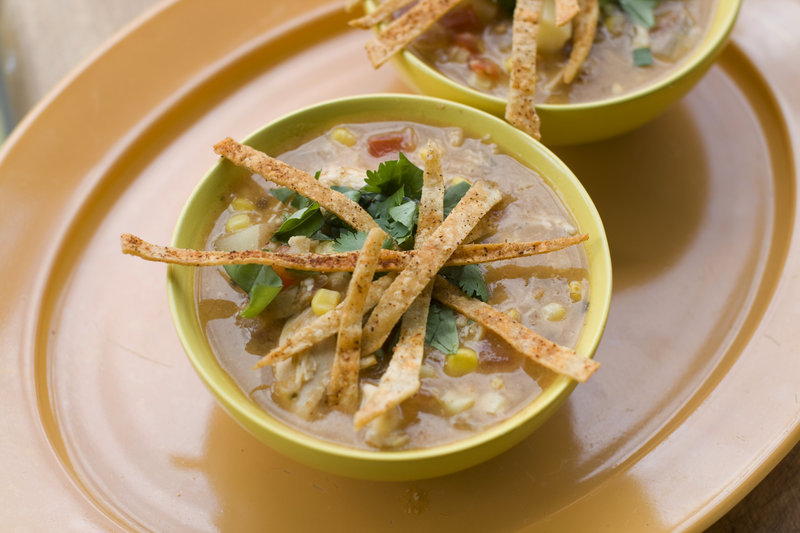 Bowls of southwestern corn and chicken chowder are garnished with crisp tortilla strips. The recipe calls for fresh corn, which thickens and adds flavor to the soup.