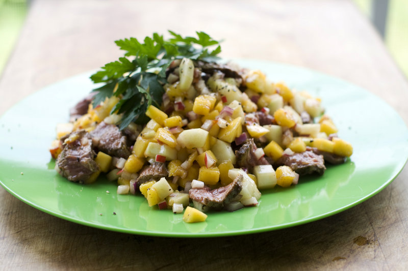 Chili mango-beef salad is made with a child’s favorite steak and nice chunks of fruit. Radishes and onions, less beloved by some kids, are finely chopped.