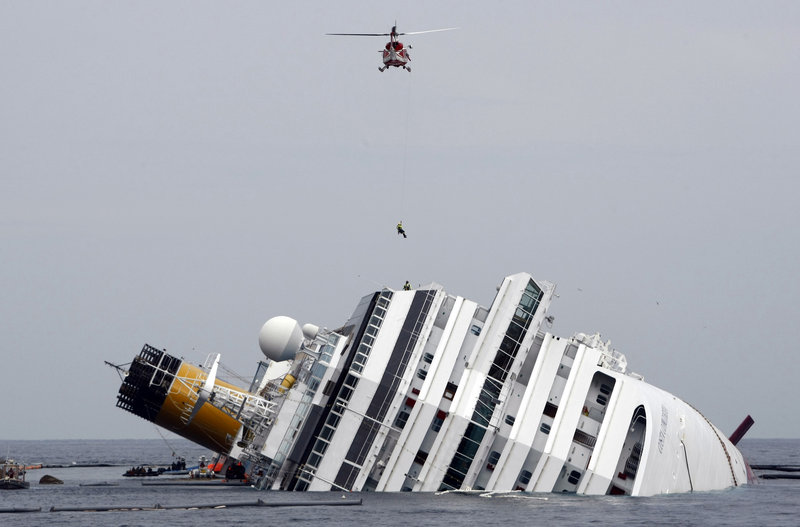 An Italian firefighter is lowered from a helicopter onto the Costa Concordia off Giglio, Italy, on Jan. 31, 2012. The ship’s captain was denied a plea bargain and is being tried separately.