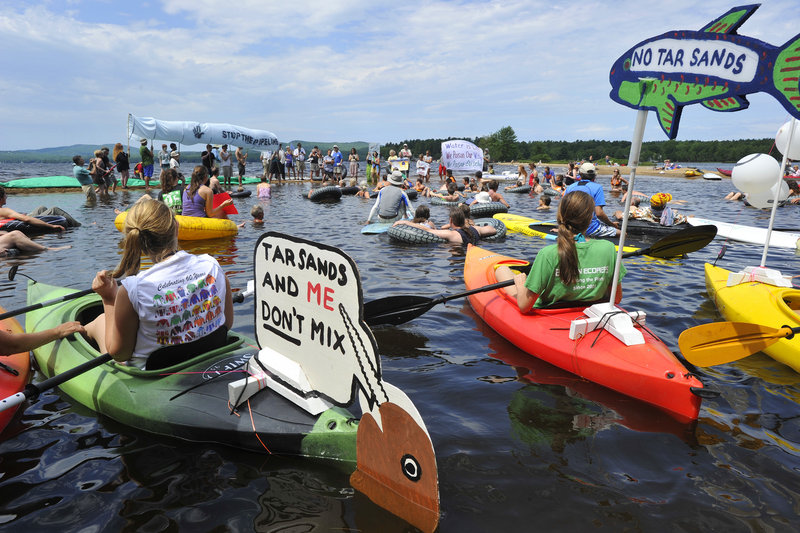 A flotilla at Sebago Lake State Park on Saturday protests against transporting tar sands oil through Maine.
