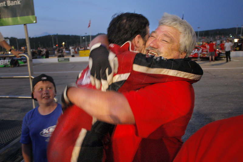 Travis Benjamin, left, gets a bear hug from pit crew member Howard Whitney on Sunday. Benjamin credited adjustments to his car for helping him to win the TD Bank 250.