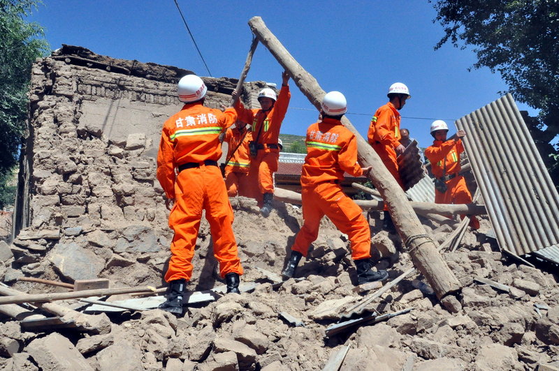 Rescuers clear the debris of a damaged house in the Majiagou village in northwest China’s Gansu province after an earthquake struck early Monday morning. The quake’s magnitude was estimated at 5.9-6.6.