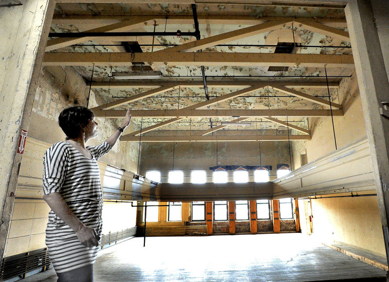 Tammy Ackerman of the nonprofit arts organization Engine is seen here on the third floor of the former Renys store called the Marble Block in downtown Biddeford, where a theater stage and balcony remain.