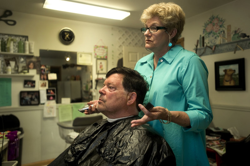 Hairdresser Jane Good of Southport Island talks about the proposed closure of St. Andrews Hospital in Boothbay Harbor with summer resident Walter Weil. Good's salon has become an epicenter of support for keeping the hospital alive in the community.