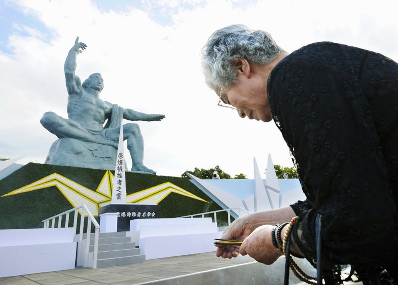 A woman prays Aug. 9, 2008, in front of the Statue of Peace, hours ahead of a ceremony to mark the 1945 atomic bombing of Nagasaki, Japan. Maine voters must contact congressional delegation members about heeding President Obama’s recent call for further nuclear stockpile cuts, a reader says.