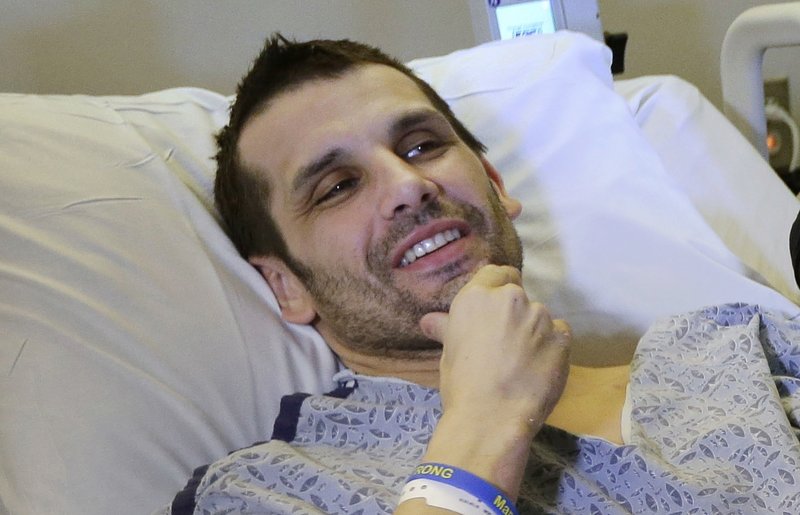 In this Thursday, May 9, 2013 photo, Marc Fucarile smiles while speaking with reporters, in Boston. Fucarile, who lost a leg during an explosion at the Boston Marathon, was released from the Spaulding Rehabilitation Hospital Wednesday July 24, 2013, exactly 100 days after the attack that killed three people and wounded more than 260. He is the last hospitalized victim of the Boston Marathon bombings to be discharged. (AP Photo/Steven Senne)