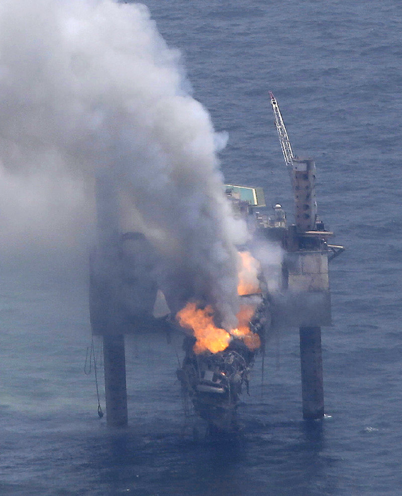 A fire blazes on the Hercules Offshore Inc. drilling rig off the coast of Louisiana on Wednesday. Natural gas spewed uncontrolled from the well Tuesday after a blowout that forced the evacuation of 44 workers.