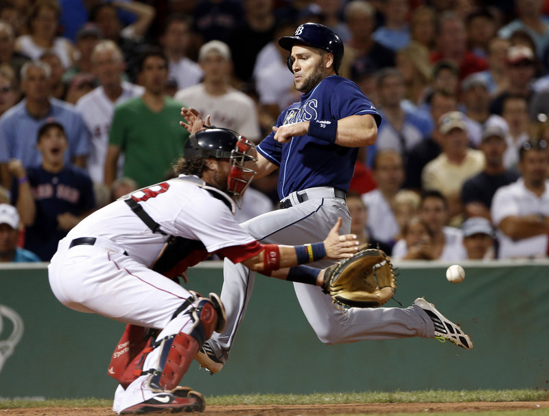 Luke Scott of the Tampa Bay Rays scores on a single by James Loney in the eighth inning Wednesday night as catcher Jarrod Saltalamacchia of the Boston Red Sox prepares for the late throw. Tampa Bay won 5-1 at Fenway.