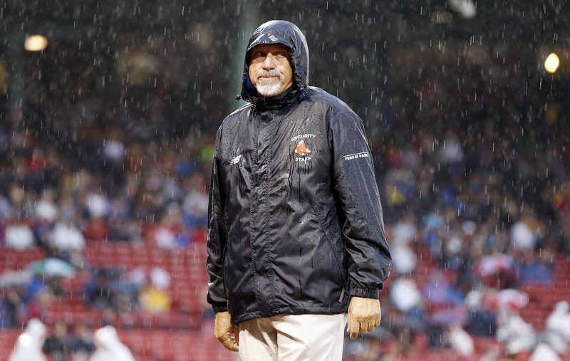 It was a wet night in Boston, as this Fenway Park security guard can attest. The game between the Red Sox and Rays was postponed to Monday.