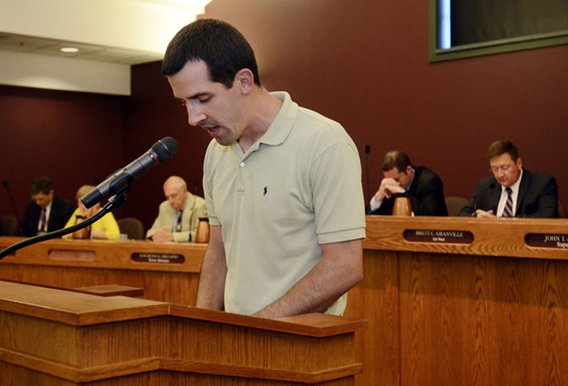 Nathan Miller leads a brief opening prayer at a town board meeting in Greece, N.Y., on June 16.