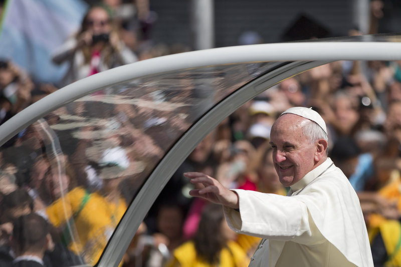 Pope Francis waves from his popemobile as he travels to the archbishop’s palace to hold a series of meetings and public noon prayer in Rio de Janeiro, Brazil, on Friday.