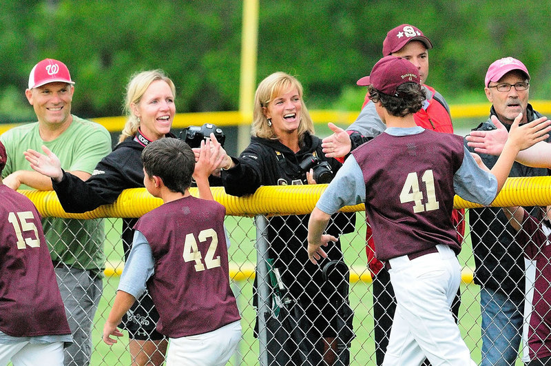 The Saco Little League players celebrated their state championship with their fans Friday night, slapping hands down the first-base line after defeating Bayside of Portland 14-1 in four innings in the final game. The teams split two earlier games this week.