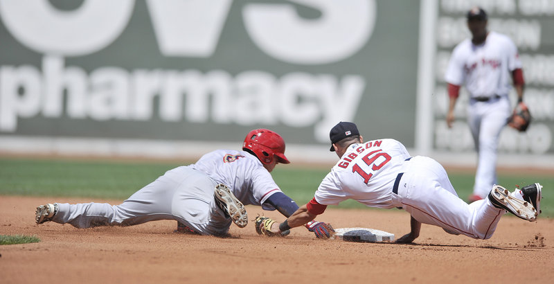 Derrik Gibson of the Sea Dogs comes up just short with a diving tag Saturday as Ricky Hague of the Harrisburg Senators reaches on a two-base error. The Sea Dogs came away with a 5-2 victory at Fenway Park.