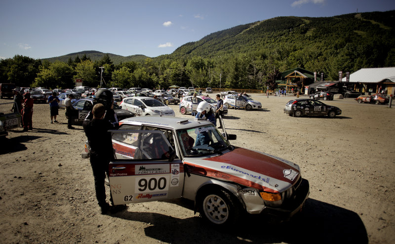 Mike White and Geoff Clark prepare to enter their Saab in the South Lodge parking lot at Sunday River on Saturday as they and other rally teams line up for the start of the second day of the New England Forest Rally.