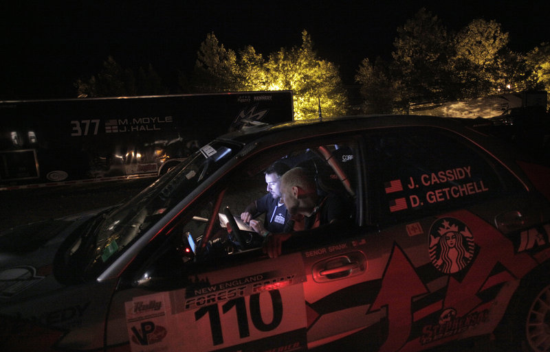 Erik Lee, in driver’s seat, and Cullen Gillis sit in the front of Last Ditch Racing’s Subaru rally car late Friday night as they go through final pre-race checks for the next day.