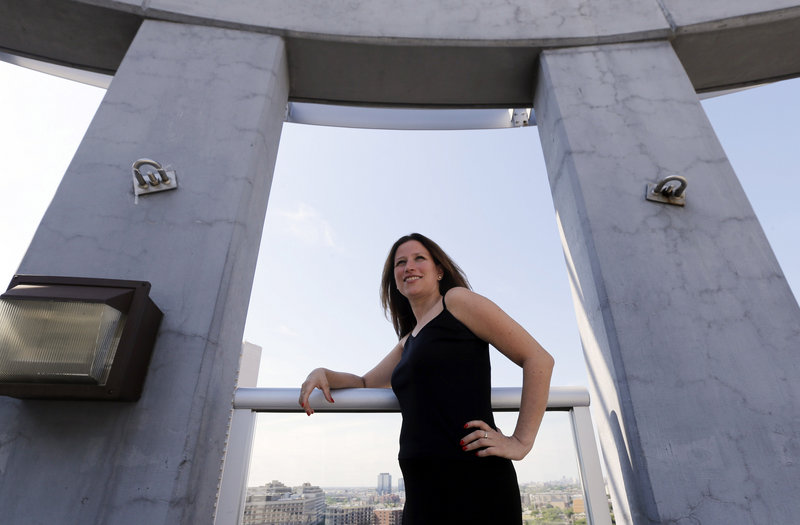 Maura Duffy, 35, poses on the deck atop her apartment building in Chicago. Adopted at birth, Duffy is among 8,800 Illinois residents who have been able to see their birth certificates after the records were unsealed in 2010.