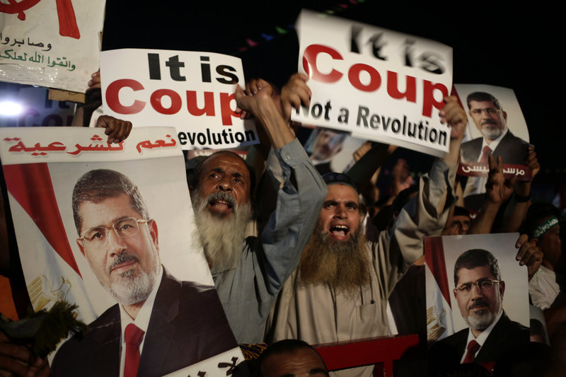 Supporters of ousted Eyptian President Mohammed Morsi chant slogans against Egyptian Defense Minister Gen. Abdel-Fattah el-Sissi in Nasr City on Sunday.