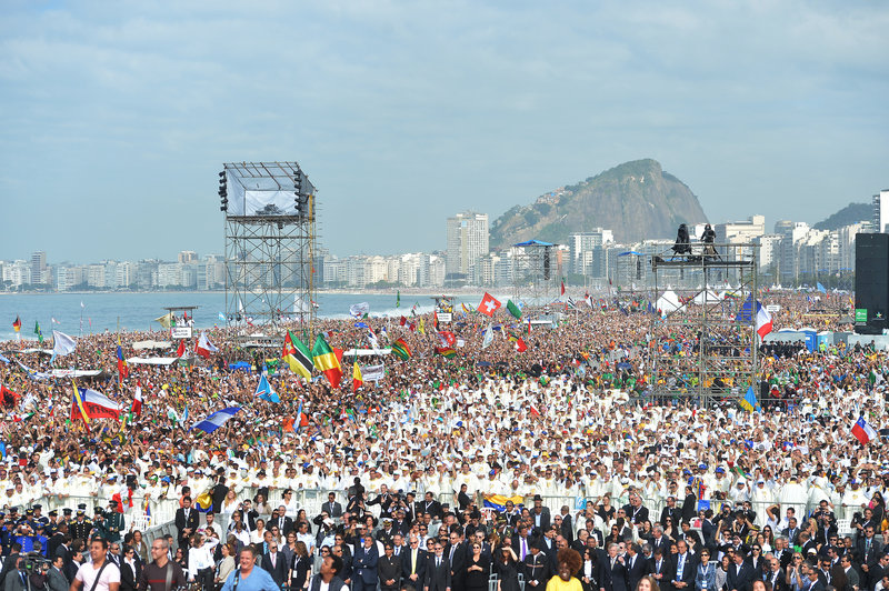 Crowds wait for the arrival of Pope Francis to celebrate Mass on Copacabana beach in Rio de Janeiro, Brazil, on Sunday. The pontiff wrapped up his historic trip to his home continent by urging young people to go out and spread their faith.