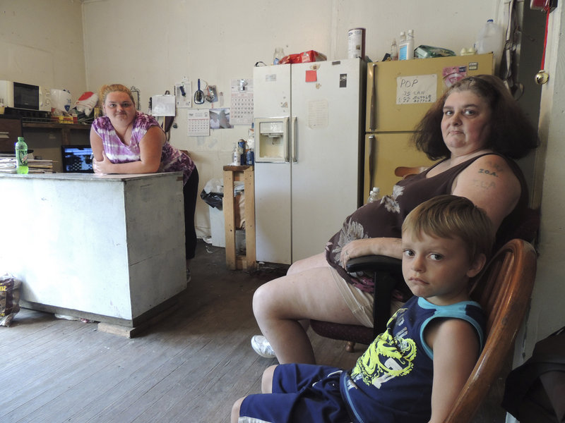 Renee Adams, left, poses with her mother, Irene Salyers, and son Joseph, 4, at their produce stand in Council, Va., where they’re trying to make a living but still depend on public assistance.